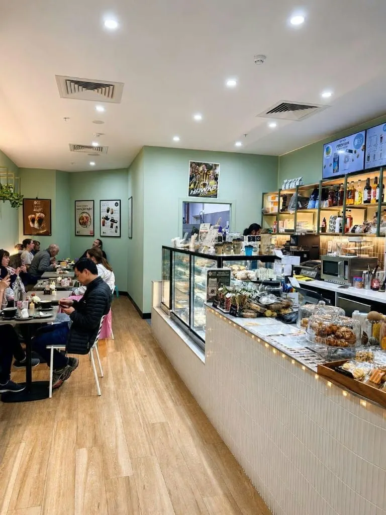 The Köfi Köfi dining room at Brandon Park, with the cake display, counter and tables