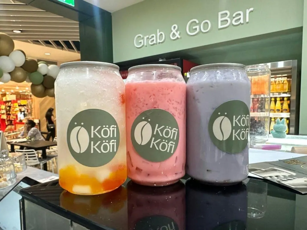 Three colourful Köfi Köfi drinks at the Grab and Go bar: mango, pink and taro